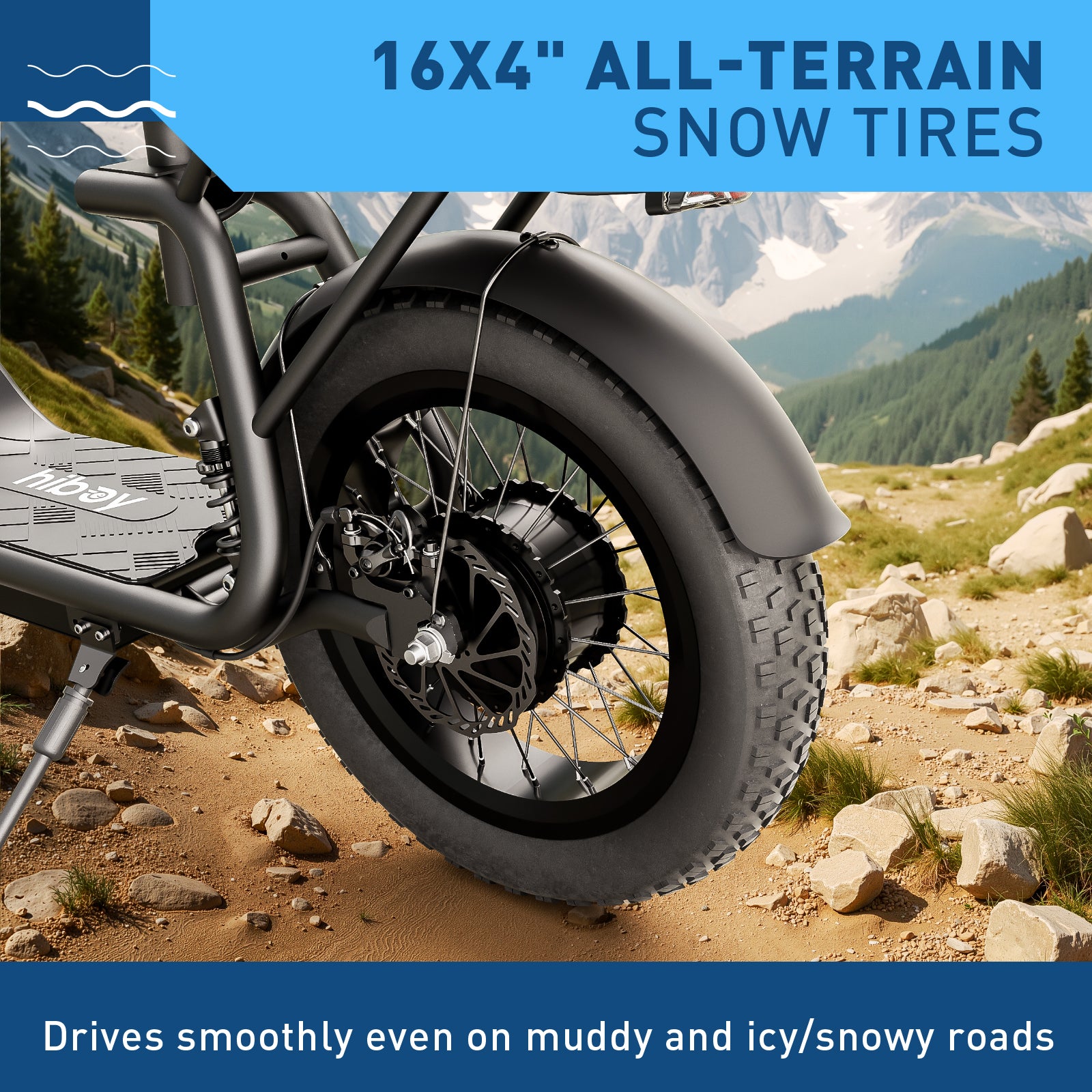 Motorcycle wheel with 16x4" all-terrain snow tires on a mountainous landscape.